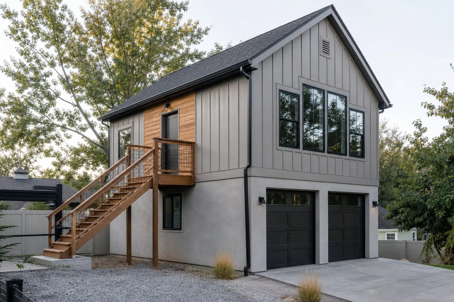 ADU above a detached garage with an exterior wood stair leading up to the entry